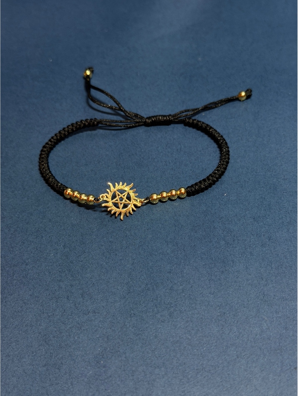 Antipossesion Charm Bracelet Gold toned with Black band